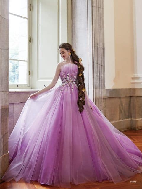 Woman wears a light purple ballgown inspired by Rapunzel