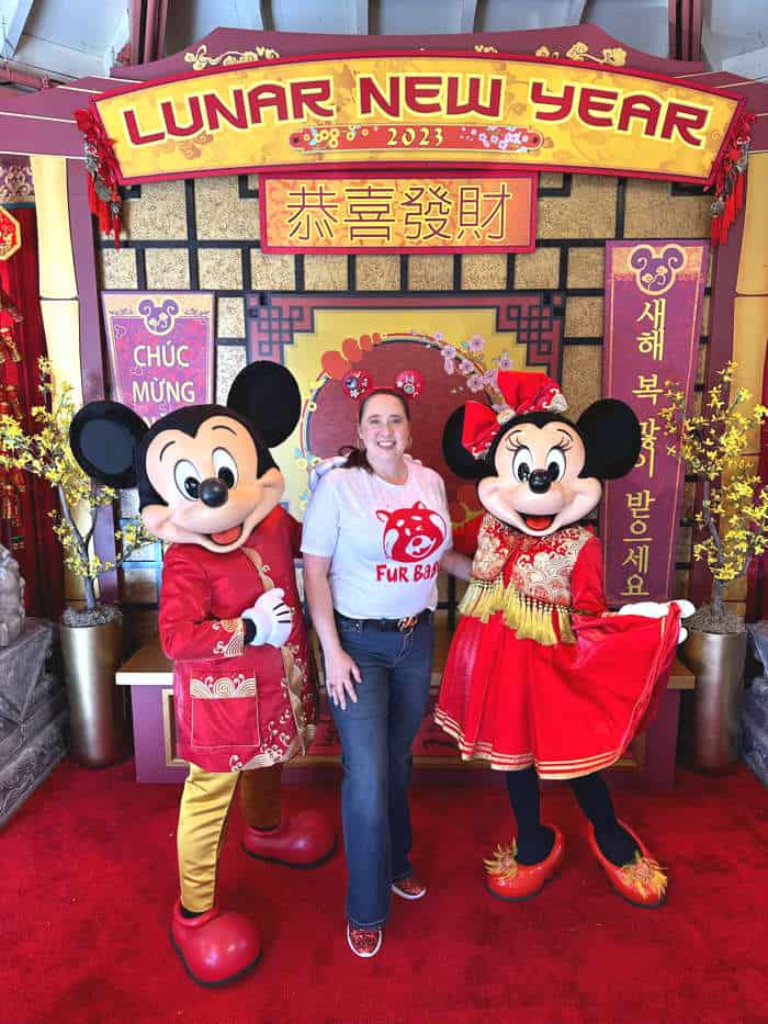 Woman poses with Mickey and Minnie for Lunar New Year festival at Disney California Adventure