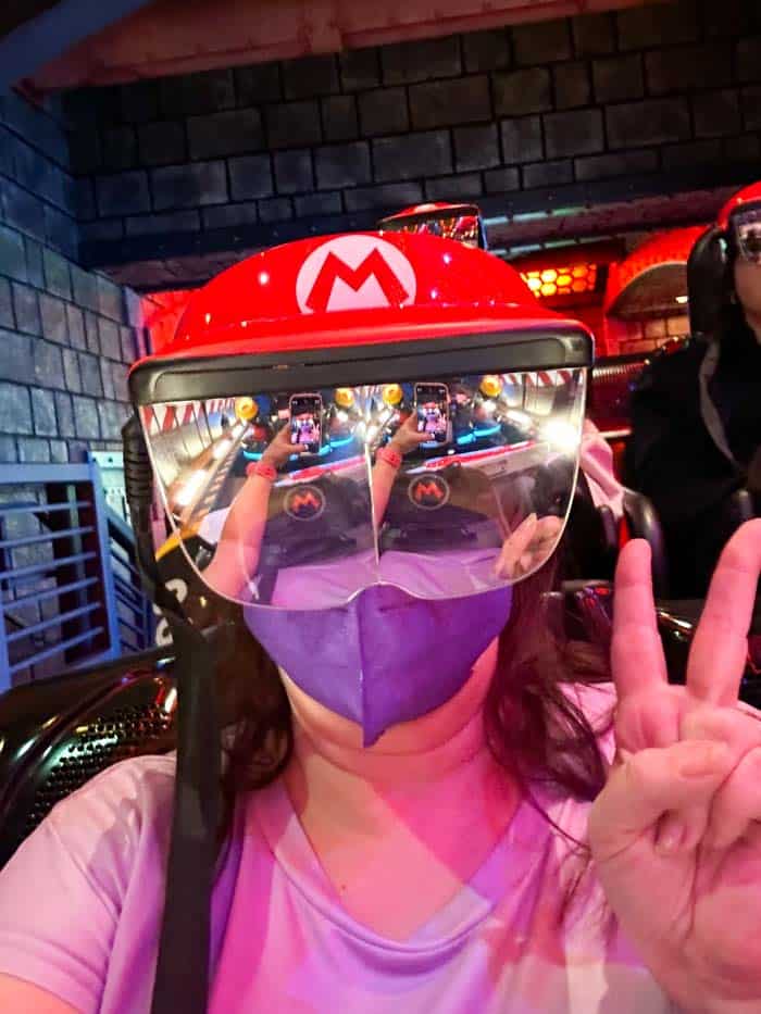 Woman poses wearing Mario Kart: Bowser's Challenge visor