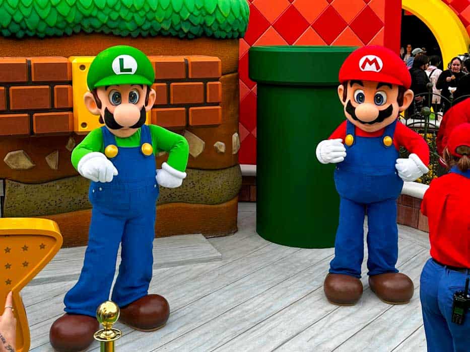 Luigi and Mario meet with guests at Super Nintendo World