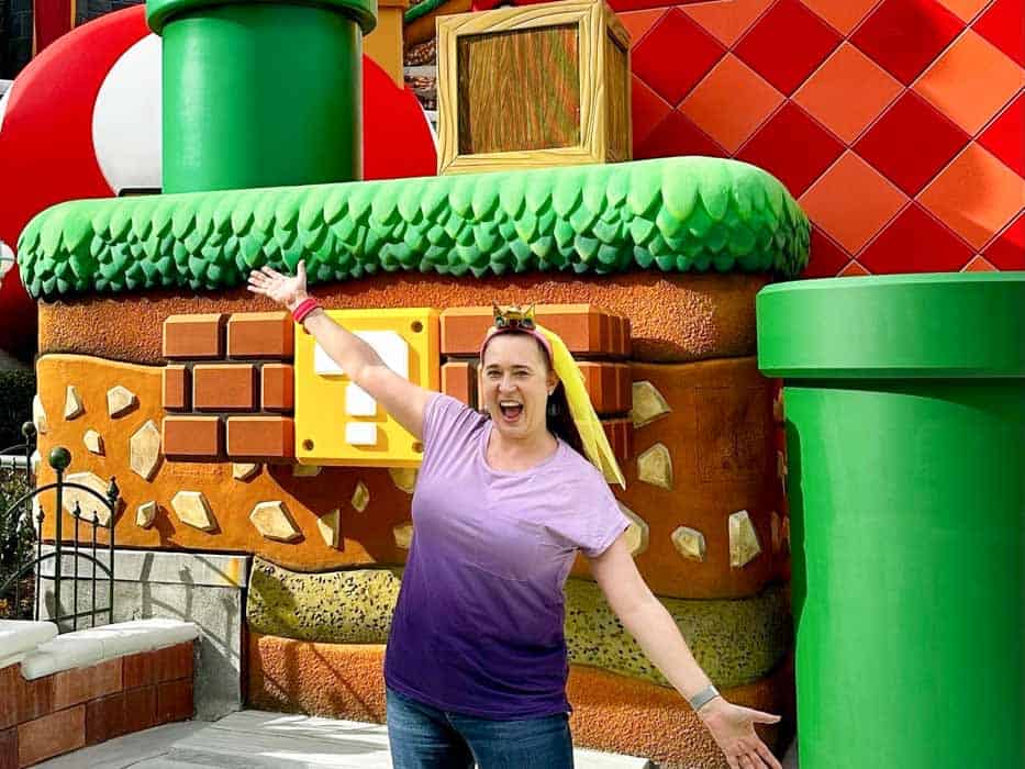 Woman standing in front of Mario meet and greet area at Super Nintendo World