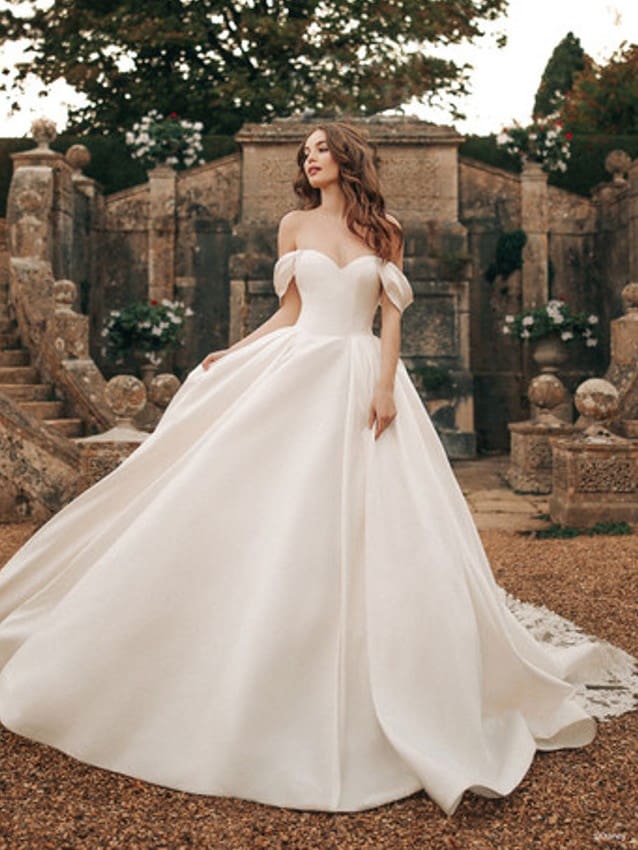 Model wears Belle inspired wedding dress