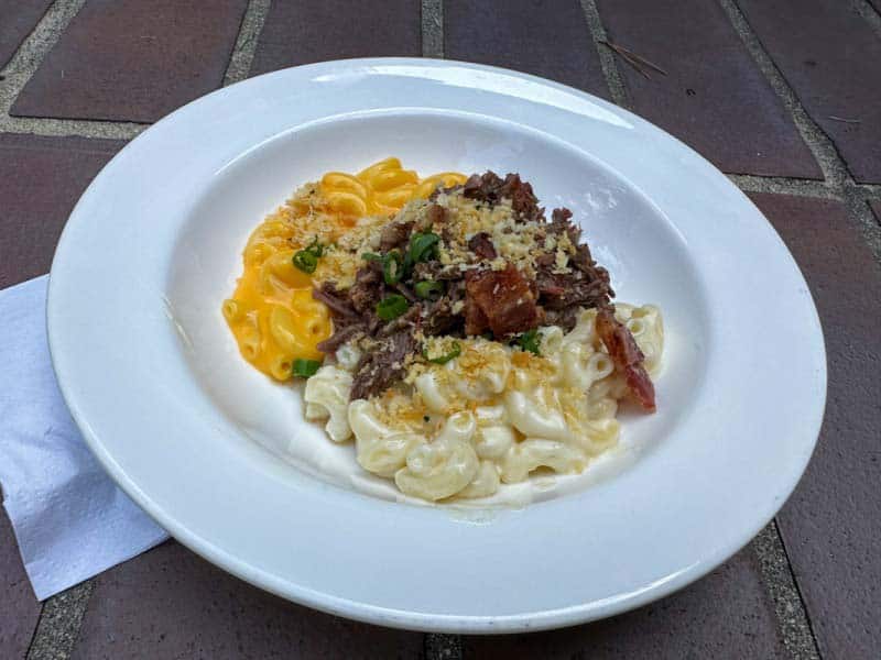 Plate of two kinds of mac and cheese and toppings