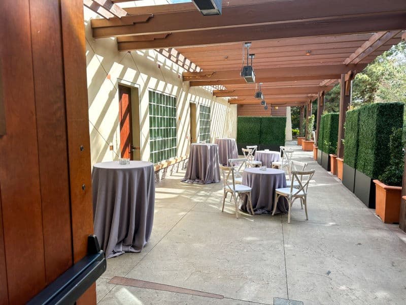 Balcony of Wisteria Room showing hi and low cocktail tables with light purple linens