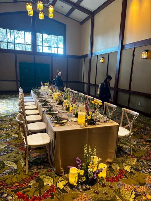 Wisteria Room set up for a wedding reception with Roman table and rustic wood chairs