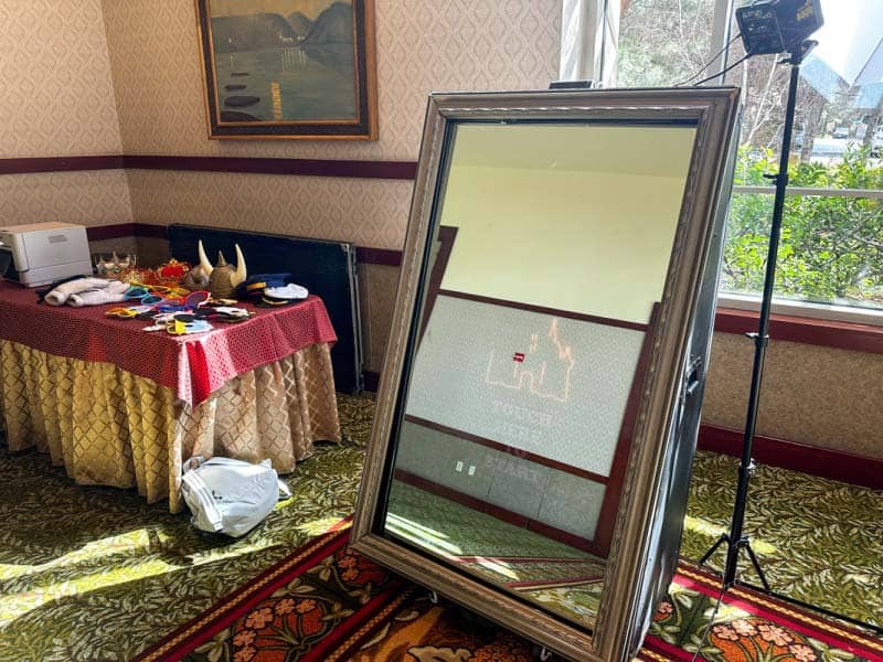 Magic Mirror photo booth on display next to table of props