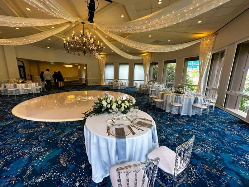 Sleeping Beauty Pavilion showing a sweetheart table with white linens and two chiavari chairs