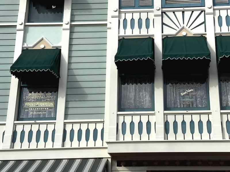 Main Street USA windows at Disneyland showing real names and fictional businesses