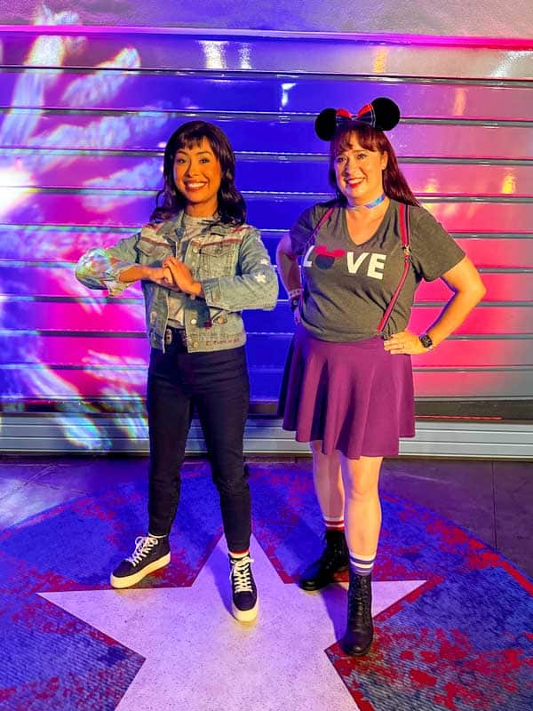 Woman poses with America Chavez on Disneyland Pride Nite