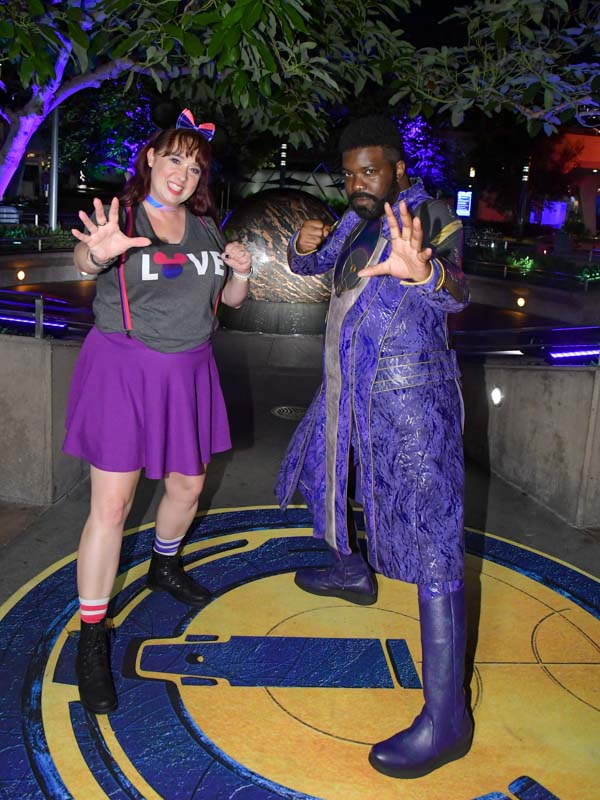 Woman poses with Phastos at Disneyland Pride Nite