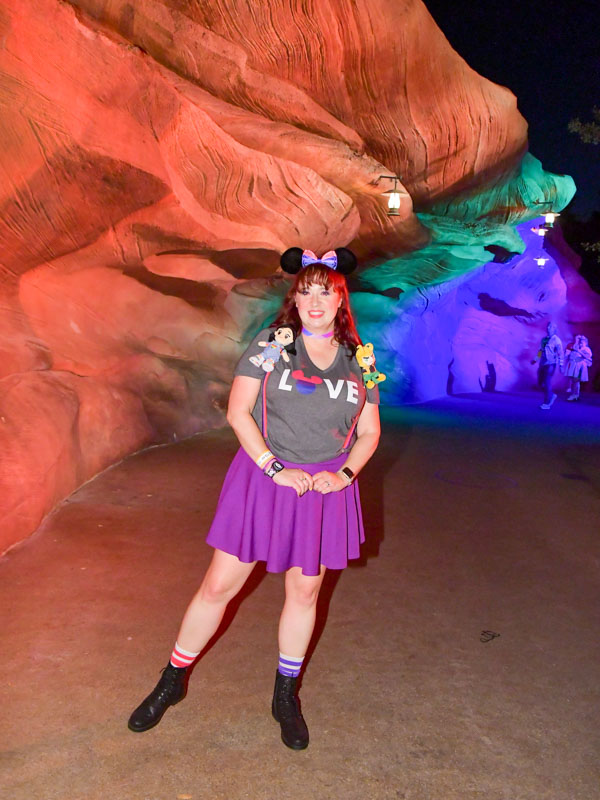 Woman poses at Rainbow Ridge at Disneyland Pride Nite