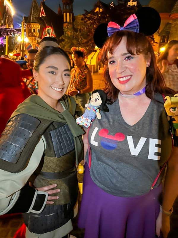 Woman poses with Ping at Disneyland Pride Nite