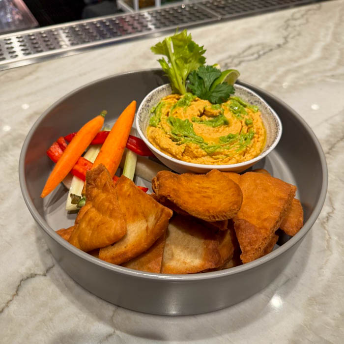 A bowl of hummus and vegetables on a counter at The Villas at Disneyland Hotel.