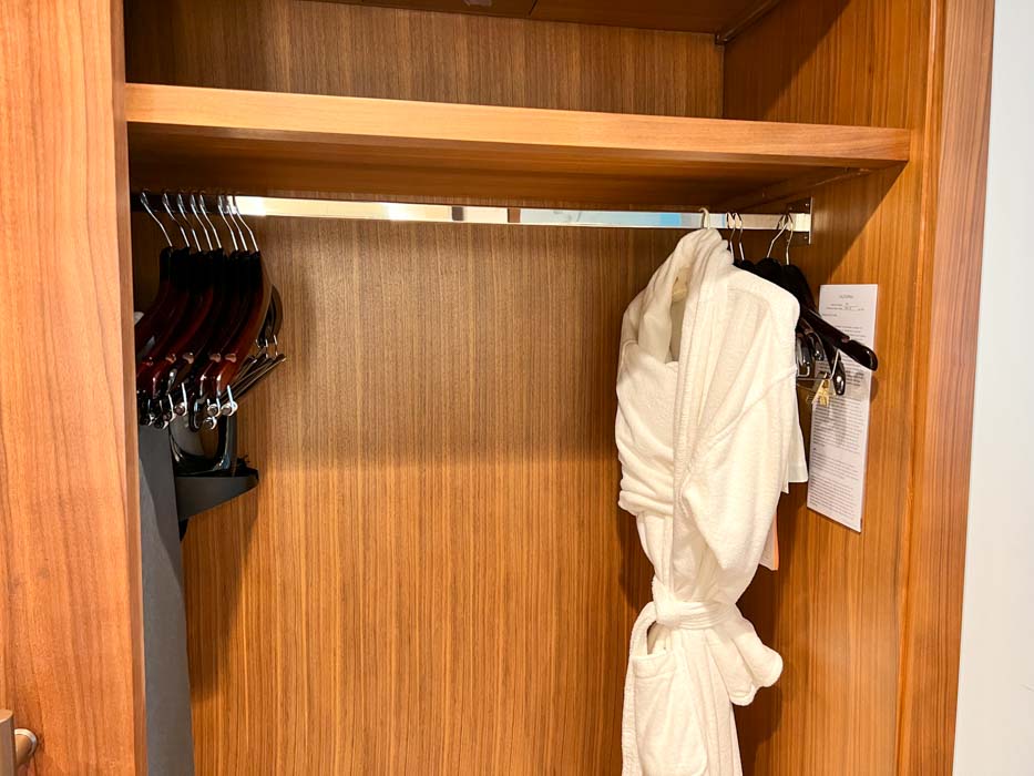 A white robe in a closet.